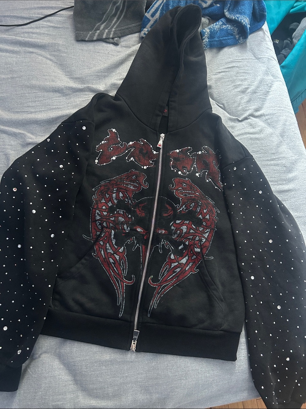 Black Zip-Up Hoodie with Red Graphic and Stud Detailing